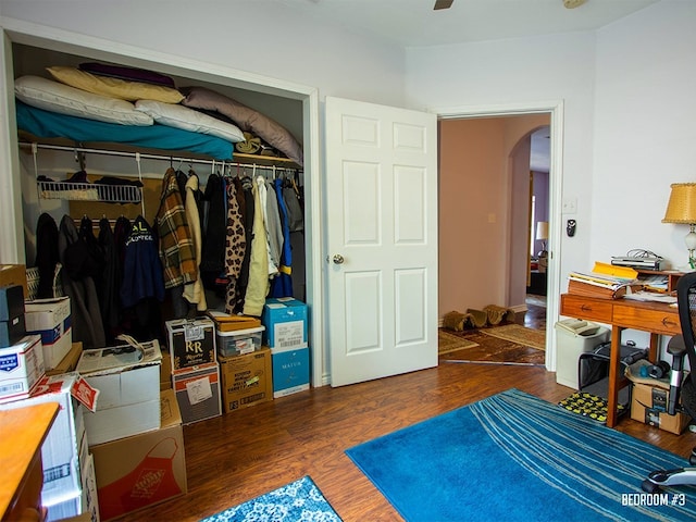 1808 Maple Ave, Austin, TX 78702 - bedroom featuring arched walkways, a closet, and wood finished floors