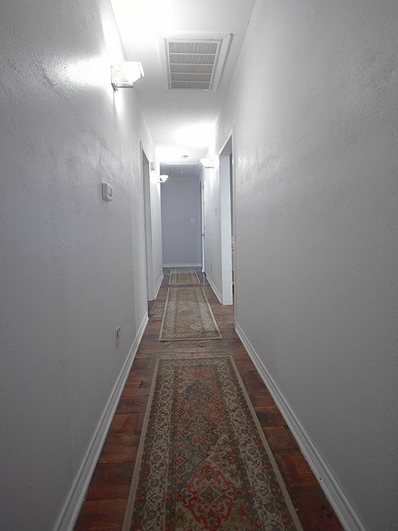 1808 Maple Ave, Austin, TX 78702 - corridor with wood finished floors, baseboards, and attic access