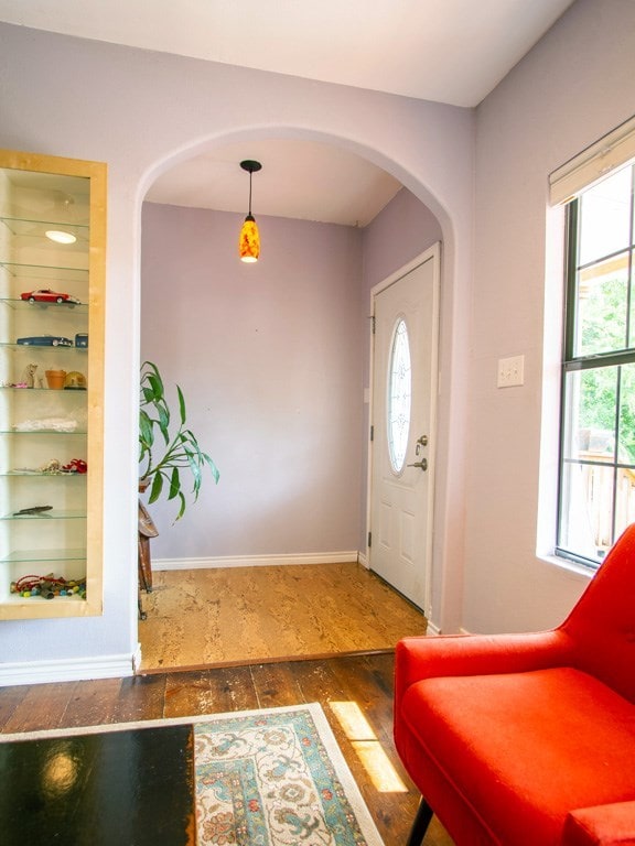 1808 Maple Ave, Austin, TX 78702 - foyer with arched walkways, healthy amount of natural light, and wood finished floors