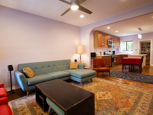 1808 Maple Ave, Austin, TX 78702 - living area featuring dark wood finished floors, recessed lighting, ceiling fan, arched walkways, and baseboards