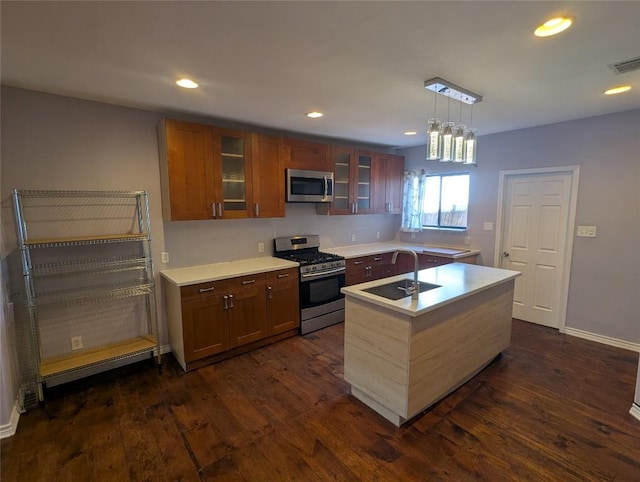 1808 Maple Ave, Austin, TX 78702 - kitchen with stainless steel appliances, a sink, dark wood-type flooring, light countertops, and recessed lighting