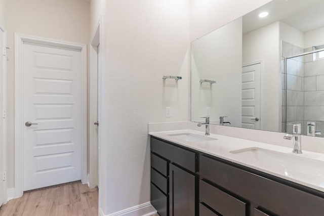 17900 Trieste Dr, Pflugerville, TX 78660 - full bath with double vanity, wood finished floors, tiled shower, and baseboards