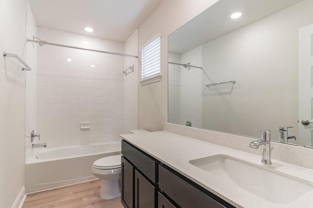 17900 Trieste Dr, Pflugerville, TX 78660 - bathroom featuring toilet, vanity, wood finished floors, washtub / shower combination, and recessed lighting