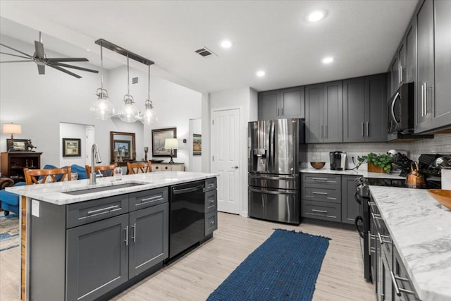 2003 Rain Water Dr, Austin, TX 78734 - kitchen with stainless steel appliances, decorative backsplash, ceiling fan, light stone counters, and recessed lighting