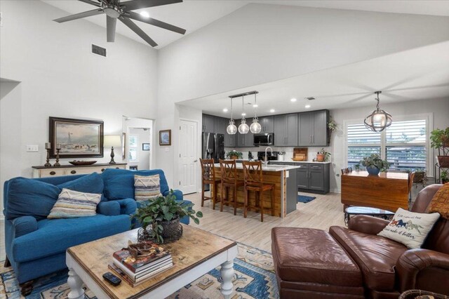 2003 Rain Water Dr, Austin, TX 78734 - living area with light wood-style floors, a ceiling fan, and high vaulted ceiling