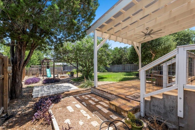 2003 Rain Water Dr, Austin, TX 78734 - fenced backyard featuring a playground, ceiling fan, and a patio area