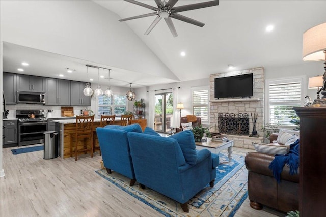 2003 Rain Water Dr, Austin, TX 78734 - living room featuring ceiling fan, high vaulted ceiling, a fireplace, light wood-style floors, and recessed lighting