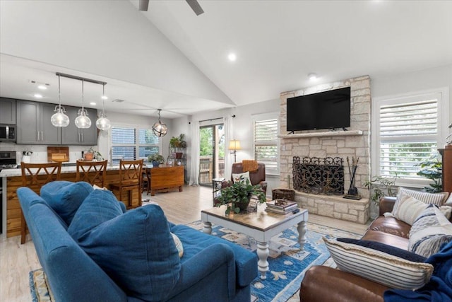 2003 Rain Water Dr, Austin, TX 78734 - living room featuring a fireplace, light wood finished floors, high vaulted ceiling, recessed lighting, and a ceiling fan
