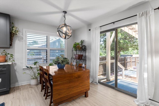2003 Rain Water Dr, Austin, TX 78734 - dining room with light wood-style floors and a chandelier