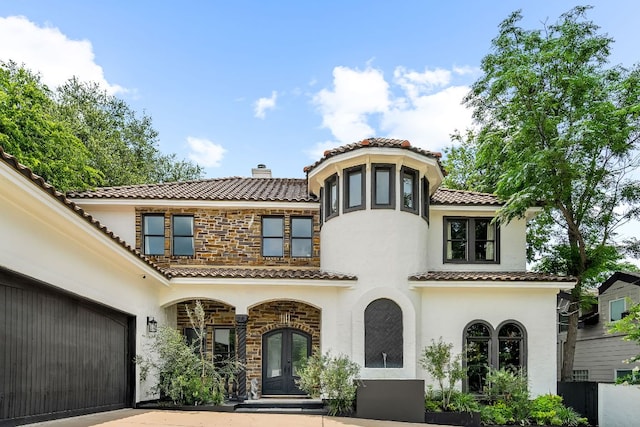 2621 Exposition Blvd, Austin, TX 78703 - mediterranean / spanish home with stucco siding, french doors, stone siding, and concrete driveway