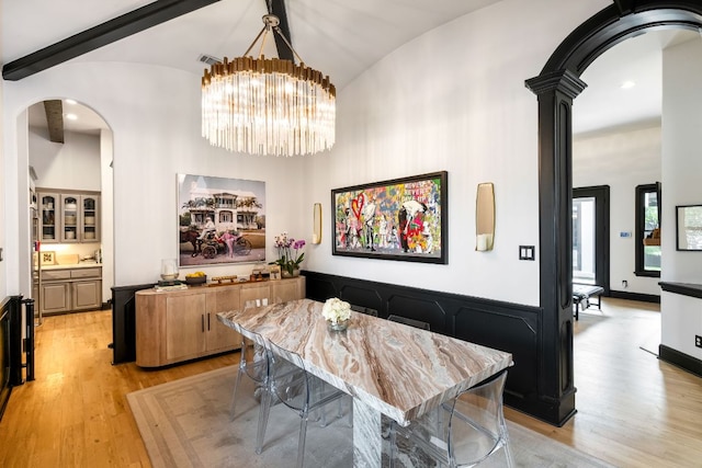 2621 Exposition Blvd, Austin, TX 78703 - dining room featuring arched walkways, light wood-style flooring, a chandelier, high vaulted ceiling, and recessed lighting
