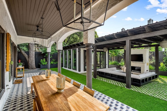 2621 Exposition Blvd, Austin, TX 78703 - wooden deck with outdoor dining space, an outdoor living space with a fireplace, a patio area, and ceiling fan