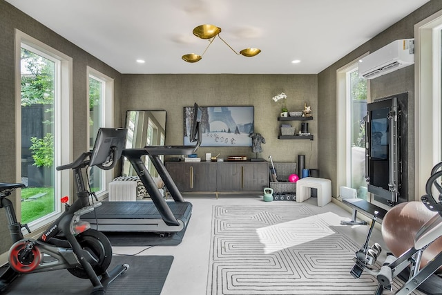 2621 Exposition Blvd, Austin, TX 78703 - exercise area featuring a wall unit AC, plenty of natural light, and wallpapered walls