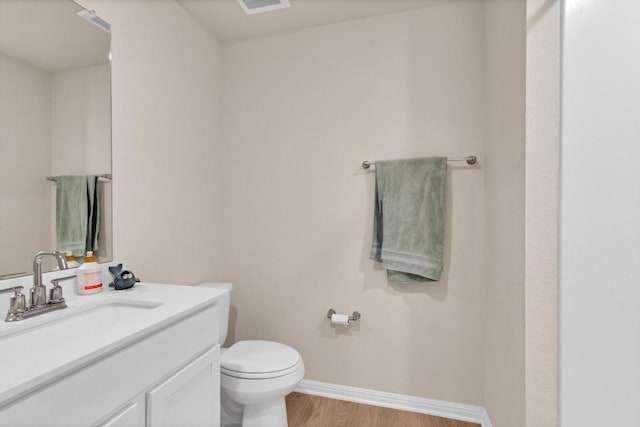 161 Grey Slate Ave, Marble Falls, TX 78654 - half bath with toilet, vanity, baseboards, and wood finished floors