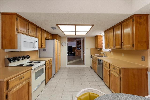 6203 Shadow Mountain Cv, Austin, TX 78731 - kitchen featuring white appliances, a sink, light countertops, brown cabinets, and a textured ceiling