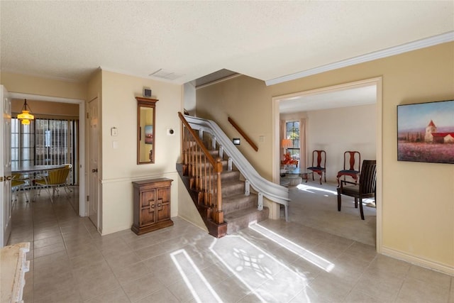6203 Shadow Mountain Cv, Austin, TX 78731 - stairway featuring tile patterned floors, a textured ceiling, crown molding, and baseboards