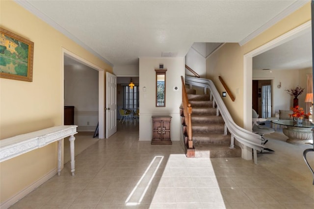 6203 Shadow Mountain Cv, Austin, TX 78731 - foyer entrance with stairs, light tile patterned floors, and crown molding
