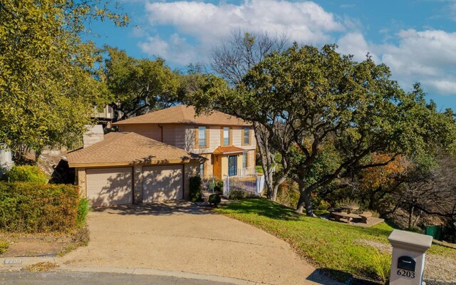 6203 Shadow Mountain Cv, Austin, TX 78731 - traditional home with an attached garage, concrete driveway, a front lawn, and a chimney
