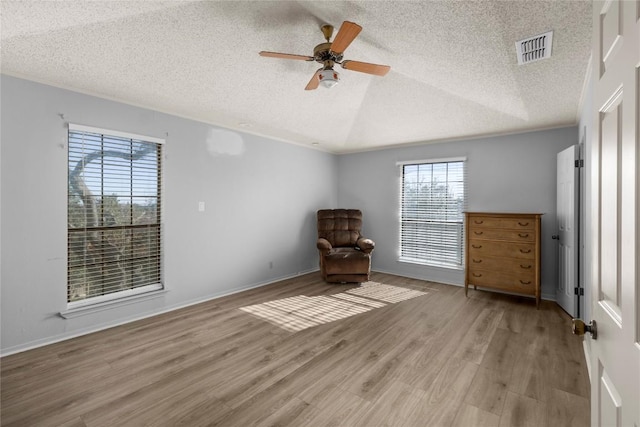 6203 Shadow Mountain Cv, Austin, TX 78731 - unfurnished room with a textured ceiling, a ceiling fan, wood finished floors, and vaulted ceiling