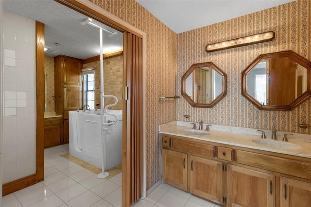 6203 Shadow Mountain Cv, Austin, TX 78731 - bathroom with wallpapered walls, double vanity, tile patterned flooring, and a textured ceiling