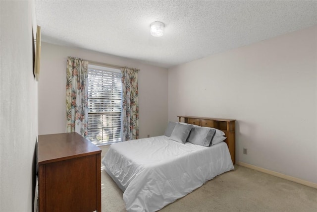 6203 Shadow Mountain Cv, Austin, TX 78731 - bedroom with a textured ceiling, light colored carpet, and baseboards