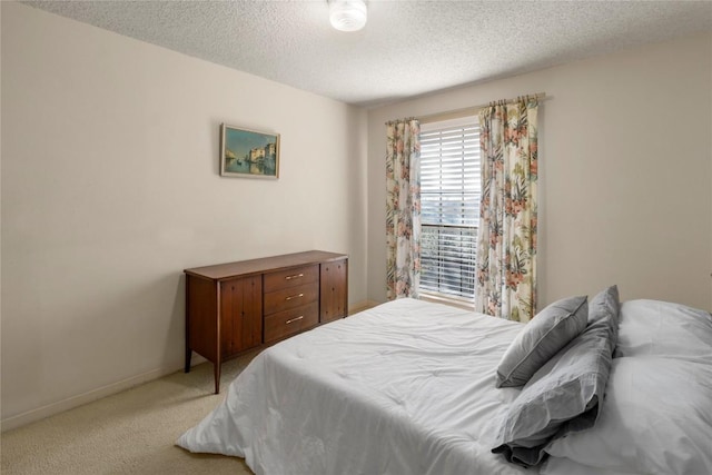 6203 Shadow Mountain Cv, Austin, TX 78731 - bedroom with a textured ceiling, light carpet, and baseboards