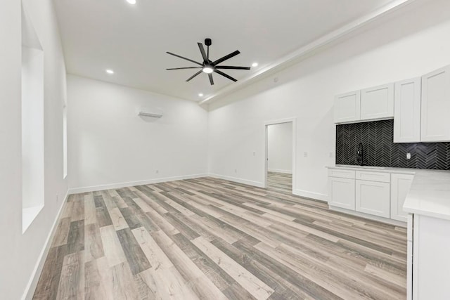 4190 W Fm 243, Bertram, TX 78605 - unfurnished living room with ceiling fan, recessed lighting, light wood-style flooring, baseboards, and a sink