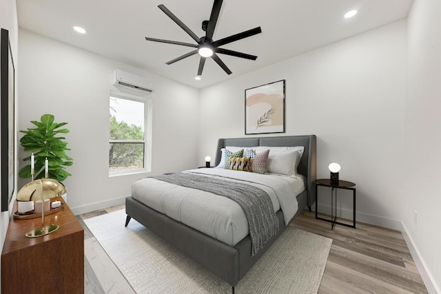 4190 W Fm 243, Bertram, TX 78605 - bedroom featuring a wall unit AC, light wood-style flooring, baseboards, recessed lighting, and ceiling fan