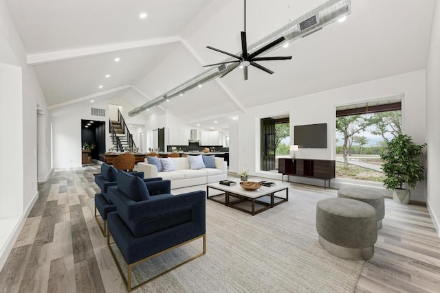 4190 W Fm 243, Bertram, TX 78605 - living room featuring stairway, light wood-style floors, high vaulted ceiling, baseboards, and beam ceiling