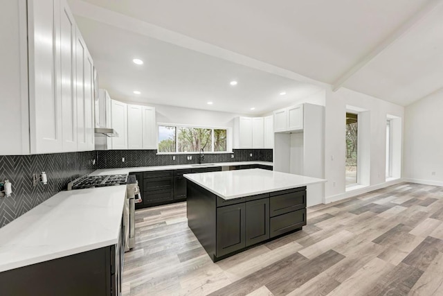 4190 W Fm 243, Bertram, TX 78605 - kitchen with a sink, backsplash, white cabinetry, light wood-style flooring, and light countertops