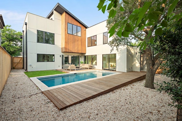 1805 Frazier Ave, Austin, TX 78704 - back of house featuring an outdoor living space, a fenced backyard, a wooden deck, an outdoor pool, and a balcony