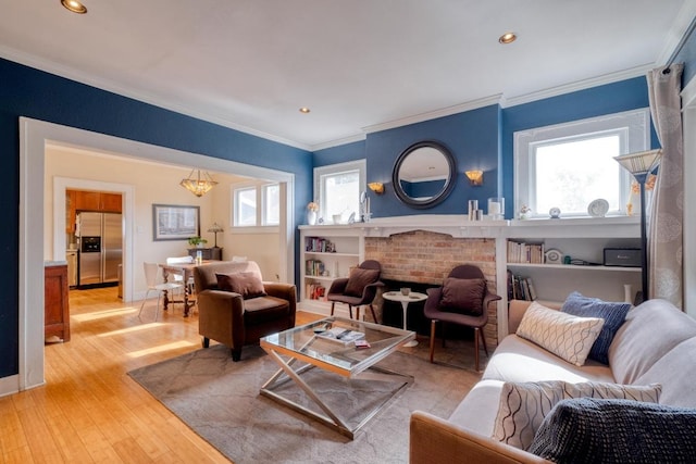 1706 Pennsylvania Ave, Austin, TX 78702 - living area featuring ornamental molding, healthy amount of natural light, light wood-style flooring, and recessed lighting