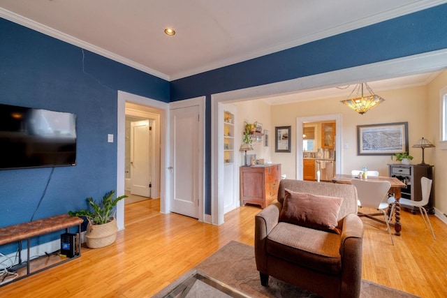 1706 Pennsylvania Ave, Austin, TX 78702 - living room featuring ornamental molding, light wood-style flooring, and recessed lighting