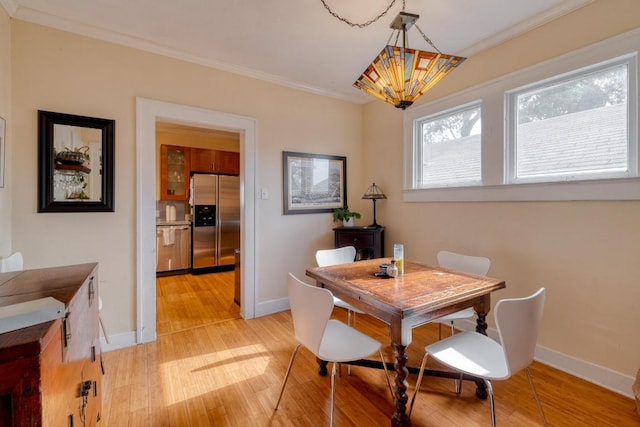 1706 Pennsylvania Ave, Austin, TX 78702 - dining area with a chandelier, light wood finished floors, and ornamental molding