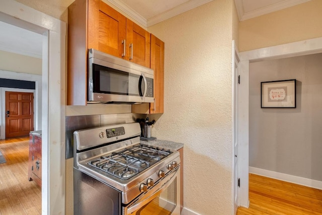 1706 Pennsylvania Ave, Austin, TX 78702 - kitchen featuring stainless steel appliances, light wood-type flooring, ornamental molding, brown cabinetry, and a textured wall