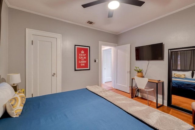 1706 Pennsylvania Ave, Austin, TX 78702 - bedroom with wood finished floors, crown molding, and a ceiling fan