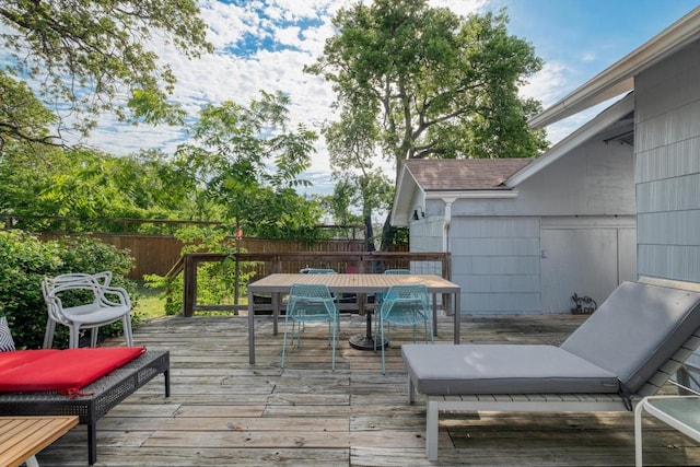 1706 Pennsylvania Ave, Austin, TX 78702 - wooden deck featuring outdoor dining space and a fenced backyard