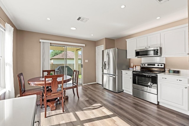 509 Big Bend Trl, Taylor, TX 76574 - kitchen with appliances with stainless steel finishes, wood finished floors, light countertops, white cabinets, and recessed lighting