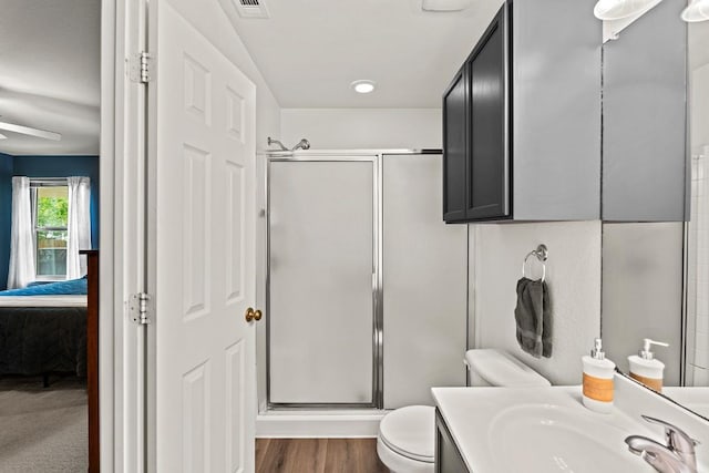 509 Big Bend Trl, Taylor, TX 76574 - full bathroom featuring a shower stall, connected bathroom, toilet, vanity, and ceiling fan