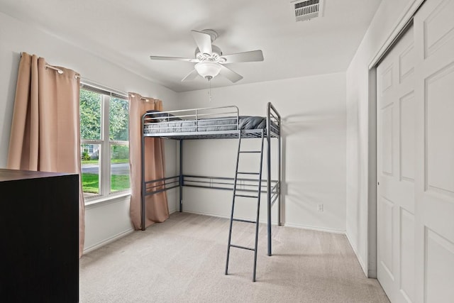 509 Big Bend Trl, Taylor, TX 76574 - unfurnished bedroom with light carpet, a closet, baseboards, and a ceiling fan
