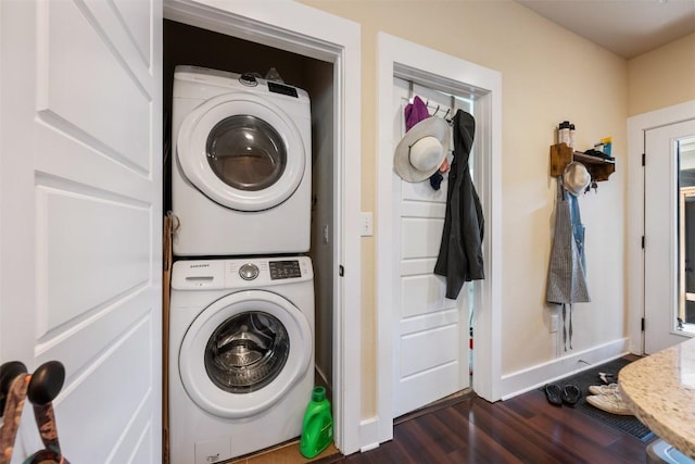 7706 Easy Wind Dr, Austin, TX 78757 - washroom with stacked washing machine and dryer, dark wood-type flooring, and baseboards