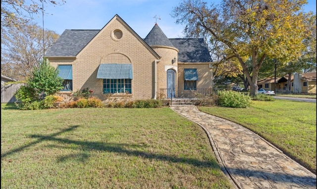 762 S Guadalupe St, Lockhart, TX 78644 - view of front of house featuring brick siding, a front lawn, and a shingled roof