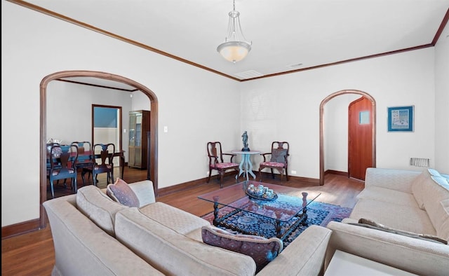 762 S Guadalupe St, Lockhart, TX 78644 - living area featuring arched walkways, wood finished floors, ornamental molding, and baseboards