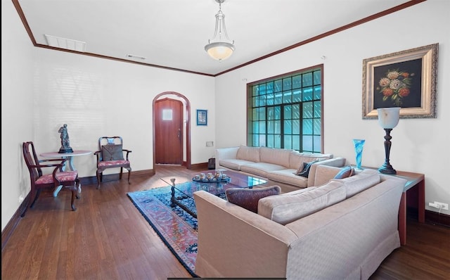 762 S Guadalupe St, Lockhart, TX 78644 - living room featuring wood finished floors, plenty of natural light, baseboards, ornamental molding, and arched walkways