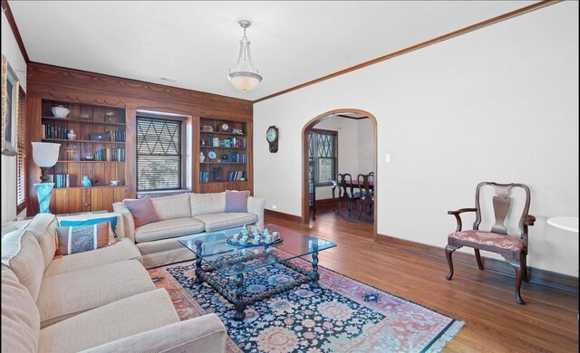 762 S Guadalupe St, Lockhart, TX 78644 - living room with arched walkways, wood finished floors, baseboards, and healthy amount of natural light