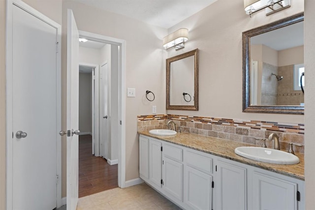 8407 Bargamin Dr, Austin, TX 78736 - bathroom with double vanity, baseboards, backsplash, and a tile shower