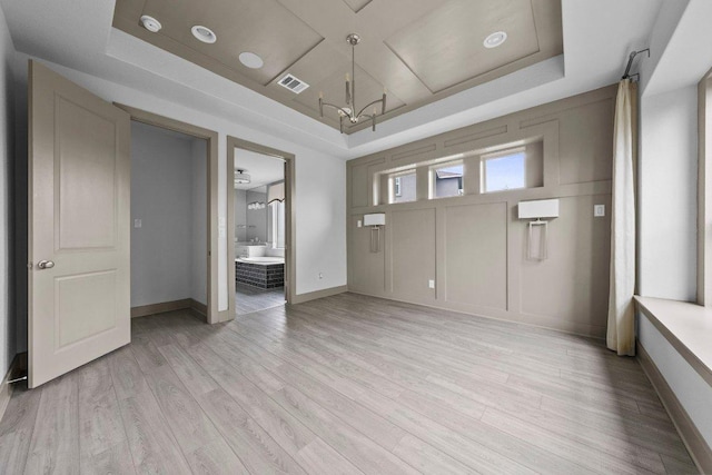 8108 Turning Leaf Cir, Lago Vista, TX 78645 - entrance foyer with a chandelier, light wood finished floors, baseboards, and a tray ceiling
