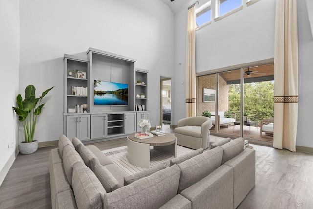 8108 Turning Leaf Cir, Lago Vista, TX 78645 - living room with a towering ceiling, light wood-style floors, baseboards, and ceiling fan