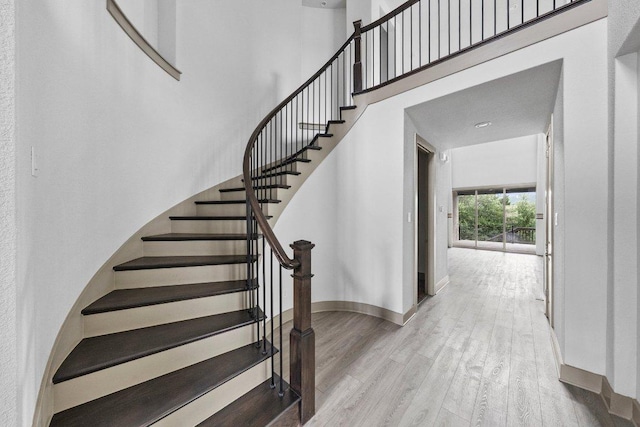 8108 Turning Leaf Cir, Lago Vista, TX 78645 - staircase with wood finished floors and baseboards