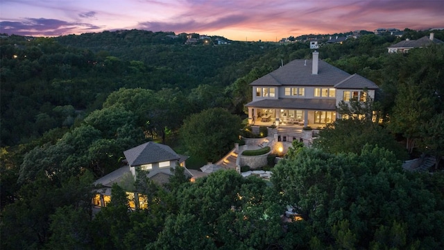 512 Newhall Cv, Austin, TX 78746 - back of property featuring a forest view and a chimney